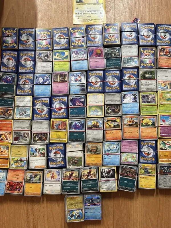 Stacks of banded Pokémon bulk cards covering a table