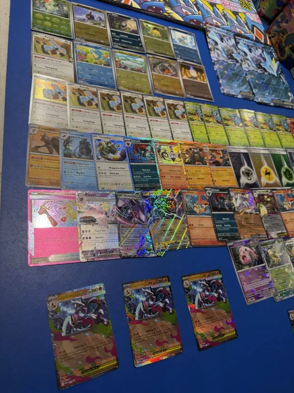 Close-up of modern Pokémon singles including holos and ex cards